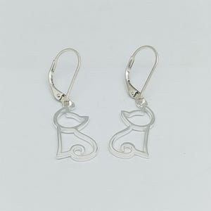 May include: A pair of silver cat silhouette earrings with leverback closures.