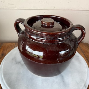 May include: A rustic wooden sign with the text "Welcome to our home" in white lettering. The sign features a distressed finish and a simple, inviting design, perfect for a front porch or entryway.