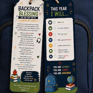 May include: A navy blue backpack featuring two rectangular tags tied to the zipper with twine. The left tag reads Backpack Blessing for the first day of elementary school, and the right tag lists goals under the heading This Year I Will.
