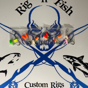 May include: A set of six fishing rigs with colorful beads and hooks. The rigs are packaged in clear plastic bags. The bags are labeled "Rig 'n Fish" and "Custom Rigs".