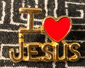 May include: Gold-colored pin with the words "I love Jesus" and a red heart.