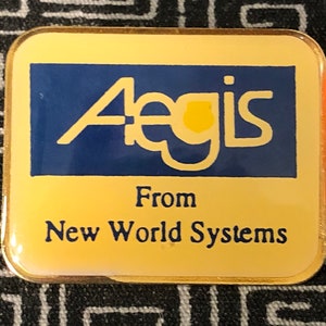 May include: A gold-colored pin with a blue and yellow logo that says "Aegis" and the text "From New World Systems".