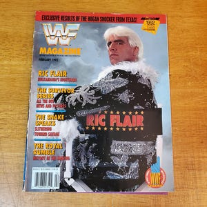 May include: A February 1992 WWF Magazine featuring Ric Flair on the cover. The magazine has a black cover with the text "Ric Flair" in gold and a photo of Flair in a black and silver sequined jacket.