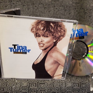 May include: A CD case with a photo of Tina Turner on the front. The title of the album is "Simply the Best" and the artist is Tina Turner. The CD is in a jewel case with a clear plastic cover.