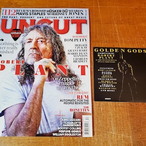 May include: A magazine cover featuring Robert Plant, the lead singer of Led Zeppelin, with the title "Uncut" and the text "Nothing is ever really finished". The cover also includes a CD with the text "Free CD Compiled by Robert Plant".