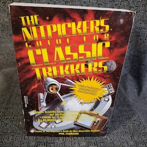 May include: A red, yellow, and black book cover with the title "The Nitpickers Guide for Classic Trekkers". The cover features a spaceship and the words "Unauthorized! Unabridged! Uncensored!" in a yellow starburst.