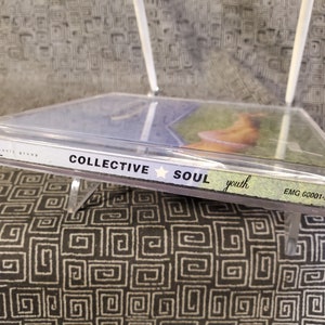 May include: A clear plastic CD case with a blue and green CD inside. The CD case has the text "Collective Soul" and "youth" printed on it. The CD case also has the text "EMG 60001-2" printed on it.