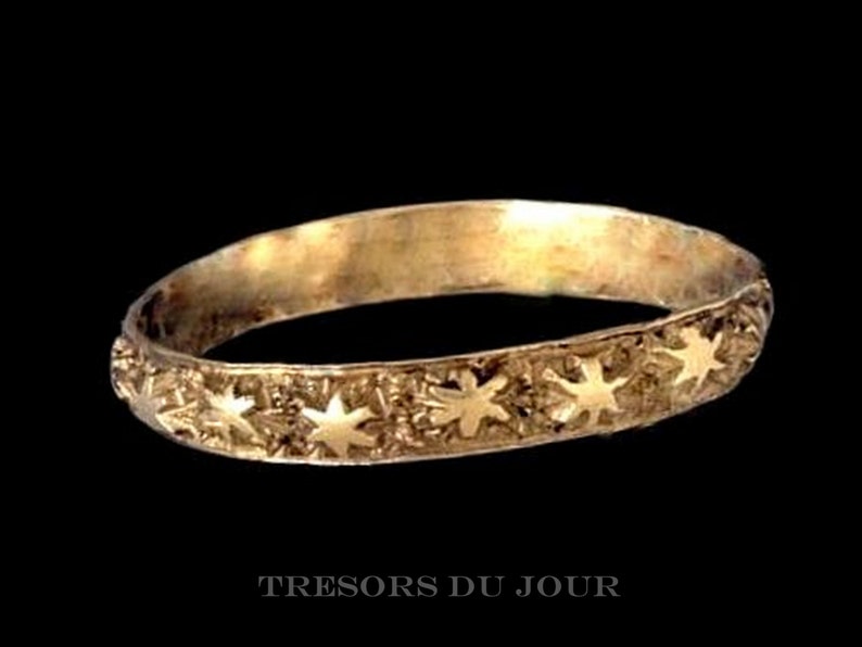 Dainty textured band featuring a line of sculpted stars is entirely custom and handmade in solid 14k or 18k yellow, rose or white gold.