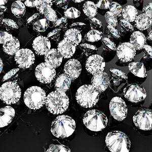 May include: A close-up of a large group of sparkling diamonds scattered on a black surface. The diamonds are various sizes and shapes, reflecting light.