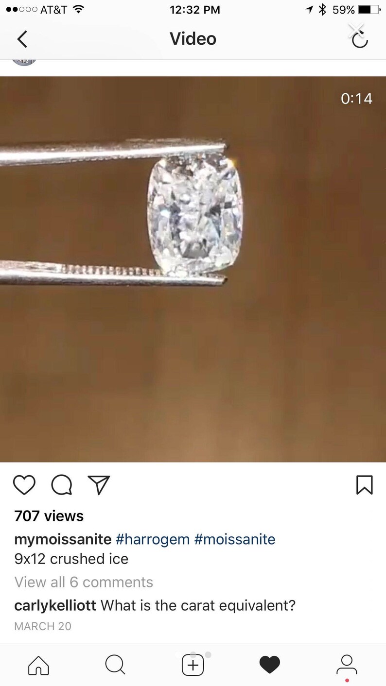 May include: A clear, cushion-cut gemstone, held by tweezers, is the focal point of this image. The gemstone has a crushed ice appearance, with a 9x12 mm size. The background is a warm, neutral tone, highlighting the brilliance of the gem.