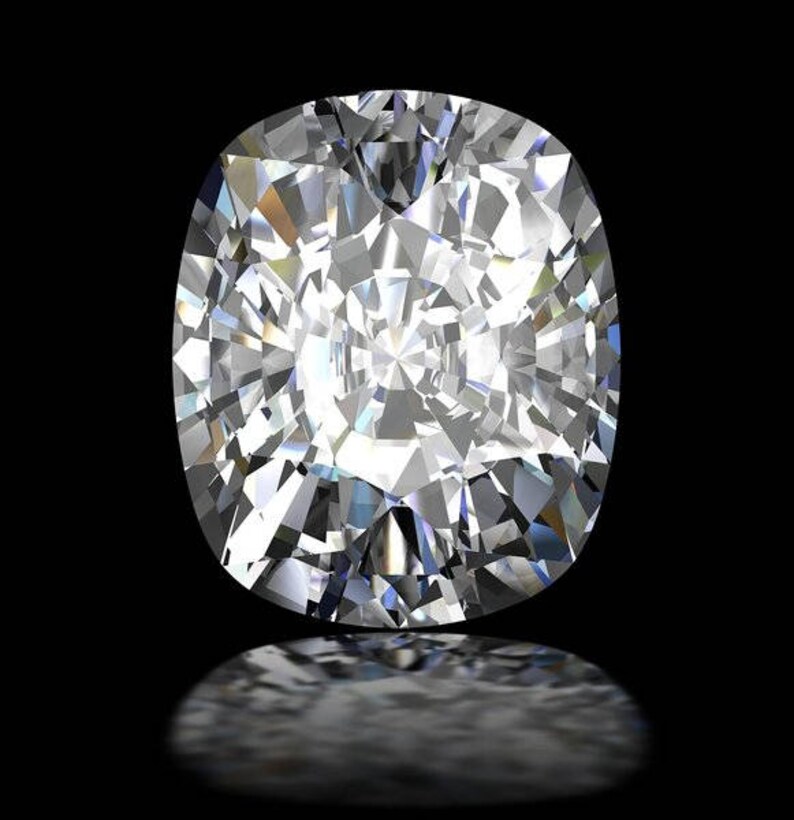 May include: A brilliant, cushion-cut diamond with numerous facets, reflecting light. The gemstone is set against a black background, with a subtle reflection below. The diamond's shape is an elongated oval.