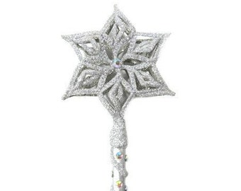 May include: A silver glitter wand with a star-shaped top. The star has a snowflake design and is accented with iridescent glitter.