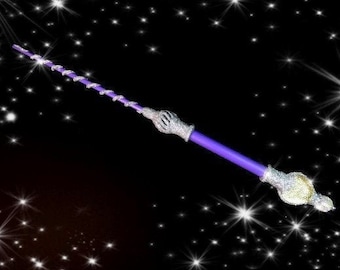 May include: A purple wand with silver glitter accents and a silver star-shaped tip. The wand is against a black background with white stars.