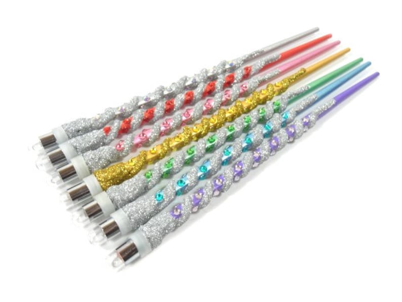 May include: A set of ten silver glitter unicorn wands with rainbow coloured tips. The wands are twisted and have a silver glitter finish.