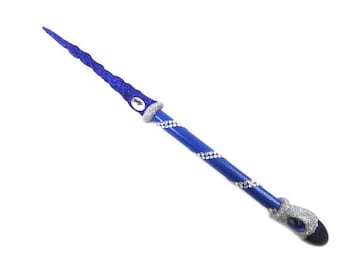 May include: A blue and silver fantasy wand with a glittery, spiraled tip. The wand features a blue shaft adorned with silver rhinestones and a silver handle with a dark blue gem. A magical accessory.
