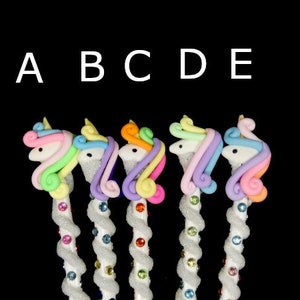 May include: Five colorful unicorn-shaped pencil toppers with white spiral pencils. The unicorn toppers are made of pastel pink, blue, yellow, and green.
