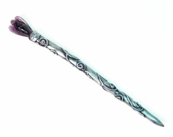 May include: A silver hair stick with a decorative floral design and a purple glass flower at the top.