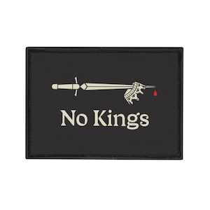 May include: Black patch with a white sword piercing a crown with a red blood drop. The text "No Kings" is below the sword.
