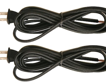 May include: Two black electrical cords with a standard US plug on each end. The cords are coiled and ready to be used.