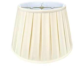May include: A cream-colored pleated lampshade with a white lining. The lampshade is round and has a smooth, even texture.