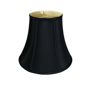 May include: A black bell-shaped lampshade with a gold inner lining.