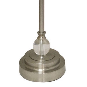 May include: A silver table lamp with a clear glass orb base and a simple, modern design.