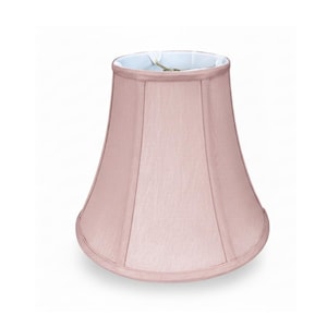 May include: A blush pink lampshade with a flared bell shape. The lampshade has a soft, fabric-like texture and a light blue interior. The seams are visible, adding to the lampshade's classic design. The lampshade is designed to be used with a lamp base.