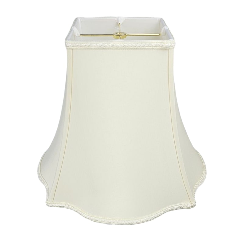 May include: A white, off-white, or cream-colored lampshade with a scalloped bottom edge. The lampshade is made of fabric and has a simple, elegant design.