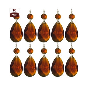 May include: Ten amber crystal teardrop chandelier prisms with silver accents. Each prism has a faceted design and is approximately 2 inches long.