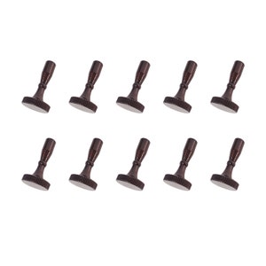May include: Twelve small, dark brown metal knobs with a round base and a cylindrical stem. The knobs have a slightly textured surface.