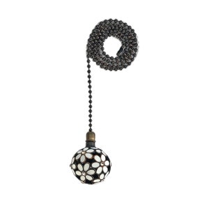 May include: A black chain with a white and black floral patterned ball at the end. The ball is about 2 inches in diameter.