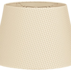 May include: A cream-colored lampshade with a subtle textured pattern. The shade is a classic drum shape with a slightly flared bottom.
