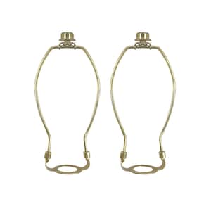 May include: Two gold metal lamp harp rings with a round base. The rings are designed to hold a lampshade.