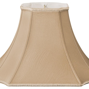 May include: A beige lampshade with a scalloped edge and a white trim. The lampshade is made of fabric and has a classic design.
