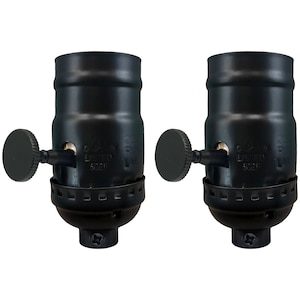 May include: Two black metal light bulb sockets with side switches. Each socket has a black plastic knob and is labeled "C-UL-US LISTED 6021E".