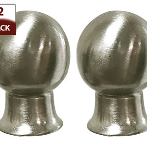 May include: Two brushed nickel finials for curtains or drapery rods. The finials are round with a smooth, polished finish and a slightly flared base.