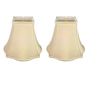 May include: A set of two beige square lampshades with scalloped edges.