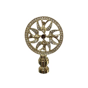 May include: Gold metal lamp finial with a round design featuring a circle of doves with a brown crystal in the center. The doves are surrounded by clear rhinestones.