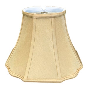 May include: A beige lampshade with a scalloped edge and a pleated design.