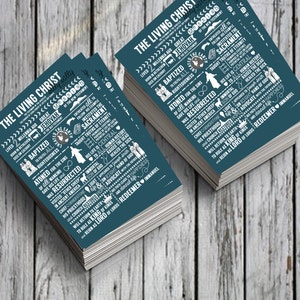 May include: A stack of teal blue cards with white text outlining the life and teachings of Jesus Christ. The text includes phrases like "The Living Christ", "Jehovah", "Baptized", "Atoned", "Resurrected", "Sacrament", "Life is Central", "Healed the Sick", "Chief Cornerstone", "Light", "His Priesthood", "Advocate", "King of Kings", "Redeemer", and "Immanuel".