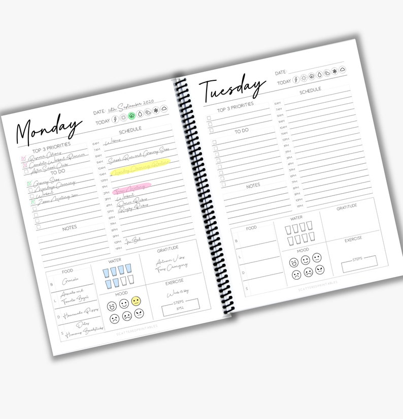 May include: A two-page daily planner with a black and white design. The left page has a section for Monday's top three priorities, to-do list, notes, food, water, mood, gratitude, and exercise. The right page has a section for Tuesday's top three priorities, to-do list, notes, food, water, mood, gratitude, and exercise.