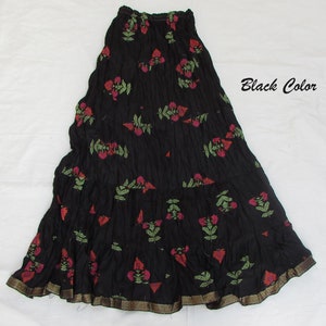 May include: A black tiered skirt featuring a crinkled texture and a repeating floral pattern in shades of red and green. The hem is finished with a metallic gold-toned border. The text "Black Color" is printed on the right side of the image.