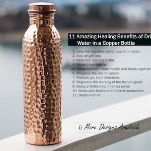May include: A copper water bottle with a hammered texture. The bottle has a screw-on lid and is displayed outdoors. Text on the image lists the benefits of drinking water from a copper bottle.