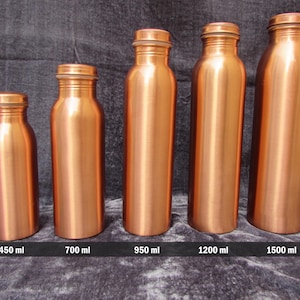 May include: Five copper-colored water bottles of varying sizes are displayed against a dark gray background. The bottles range from small to large, with capacities of 450 ml, 700 ml, 950 ml, 1200 ml, and 1500 ml. Each bottle has a matching screw-on cap.