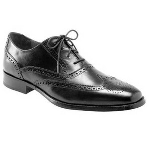 May include: A black leather oxford shoe featuring a wingtip design with decorative brogue perforations along the seams, a rounded toe, a low stacked heel, and thin black laces tied in a bow across the top of the vamp for a secure closure.