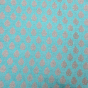 May include: A close-up of a teal fabric with a repeating pattern of light brown leaf shapes. The leaves are evenly spaced across the surface, creating a textured appearance. The fabric has a subtle sheen.