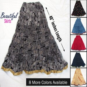 May include: A long, black and white patterned skirt with an elastic waistband and a gold-colored hem. The skirt features a 40-inch length as indicated by a measurement arrow. Additional color variations are displayed in a column on the right side.