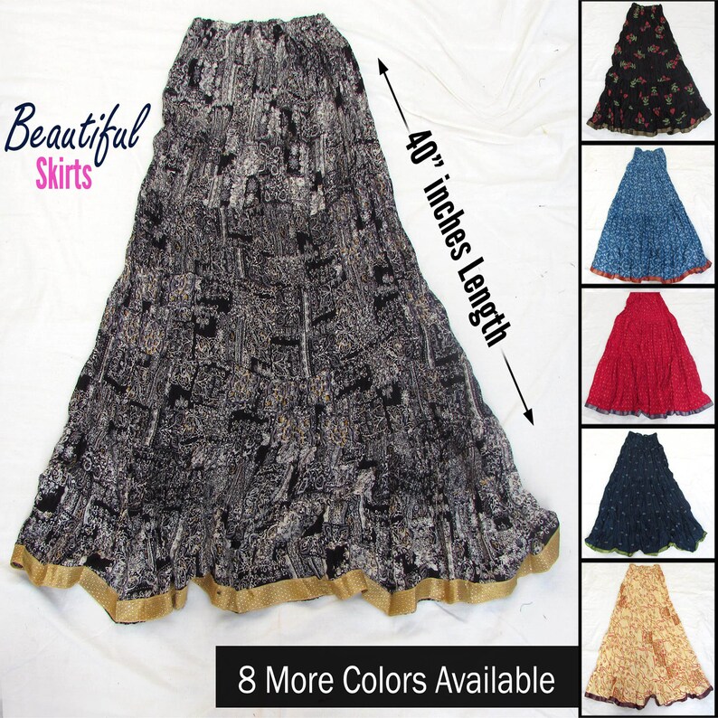 May include: A long, black and white patterned skirt with an elastic waistband and a gold-colored hem. The skirt features a 40-inch length as indicated by a measurement arrow. Additional color variations are displayed in a column on the right side.