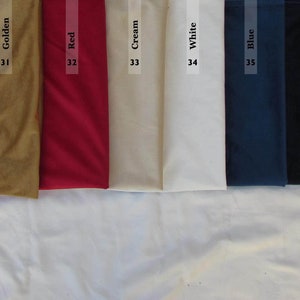 Pode incluir: Uma cole&ccedil;&atilde;o de oito amostras de tecido dispostas lado a lado, rotuladas com os n&uacute;meros 30 a 37 e os nomes das cores: Turquoise, Golden, Red, Cream, White, Blue, Dark Blue e Black. Cada amostra exibe uma cor s&oacute;lida e uniforme.