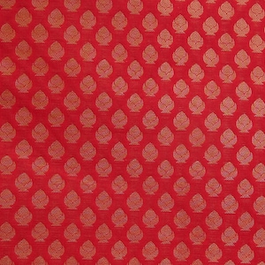 May include: A vibrant red fabric featuring a repeating pattern of small, stylized golden-yellow floral or leaf-like motifs arranged in a structured grid. The design consists of symmetrical, teardrop-shaped elements with intricate internal line details.